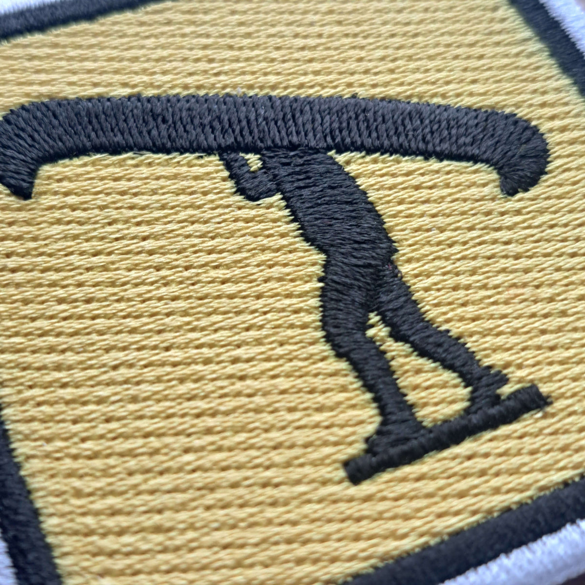 Close up of yellow and black canoehead portage embroidered patch